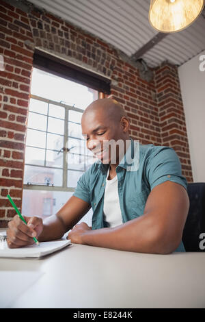 Designer sketching on paper with pencil Stock Photo