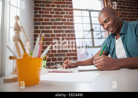 Designer sketching on paper with pencil Stock Photo