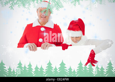 Festive older couple smiling and holding poster Stock Photo