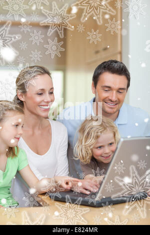 Family using laptop in the kitchen Stock Photo