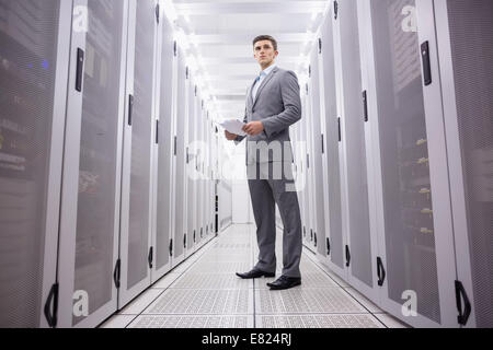 Young technician in suit standing Stock Photo