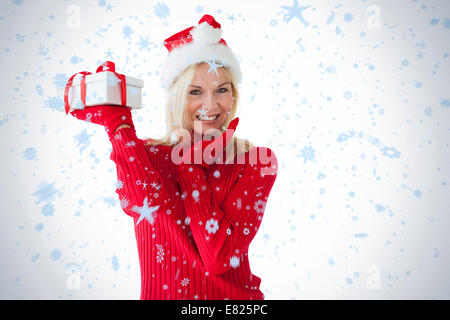 Festive blonde holding a present Stock Photo