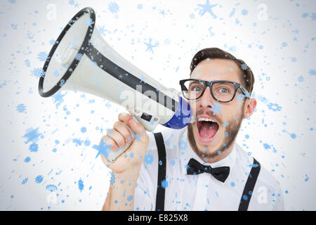Geeky businessman shouting through megaphone Stock Photo