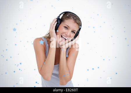 Woman singing while listening to music Stock Photo