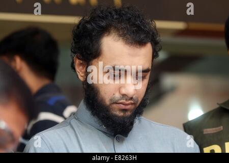 Bangladeshi police present Samiun Rahman , a British citizen of Bangladeshi origin, on suspicion of ties with global jihadist organizations in Dhaka on September 29, 2014. Bangladesh police said September 29 they arrested a British citizen suspected of entering the country to recruit militants for jihadist groups overseas such as the Islamic State organization. Stock Photo