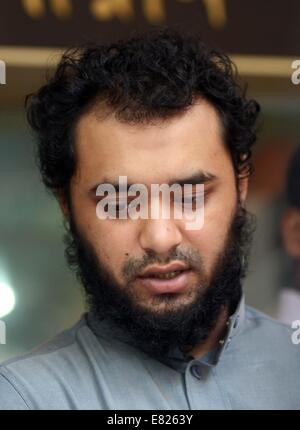 Bangladeshi police present Samiun Rahman , a British citizen of Bangladeshi origin, on suspicion of ties with global jihadist organizations in Dhaka on September 29, 2014. Bangladesh police said September 29 they arrested a British citizen suspected of entering the country to recruit militants for jihadist groups overseas such as the Islamic State organization. Stock Photo