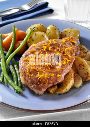 Apple pork chop with potatoes carrots green beans Stock Photo