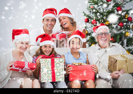 Composite image of family exchanging christmas presents Stock Photo