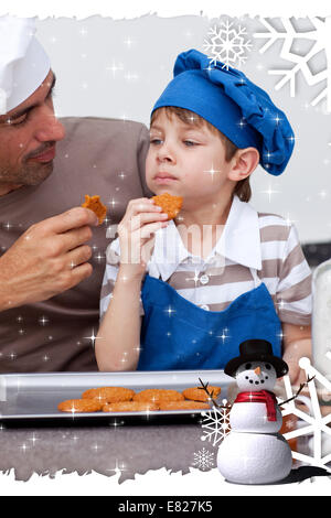 Composite image of father and son eating cookies Stock Photo