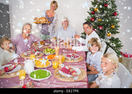 Composite image of mother bringing turkey to dinner table Stock Photo