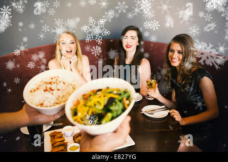 Composite image of happy friends looking at the salad Stock Photo