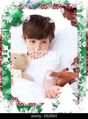 Composite image of sick little boy receiving an injection Stock Photo