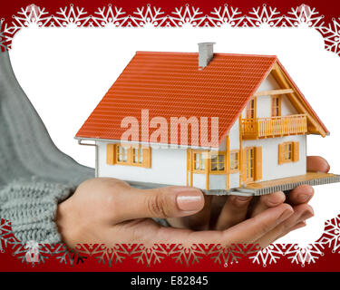 Hands showing a miniature model home Stock Photo