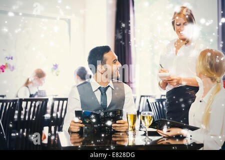 Composite image of business people ordering dinner Stock Photo
