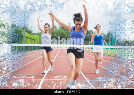 Composite image of athlete celebrates race win at finish line Stock Photo