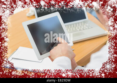 Doctors using laptop and digital tablet in meeting Stock Photo