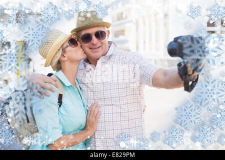 Happy tourist couple taking a selfie in the city Stock Photo