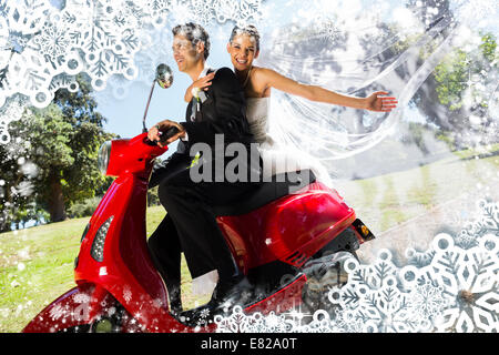 Newlywed couple enjoying scooter ride Stock Photo