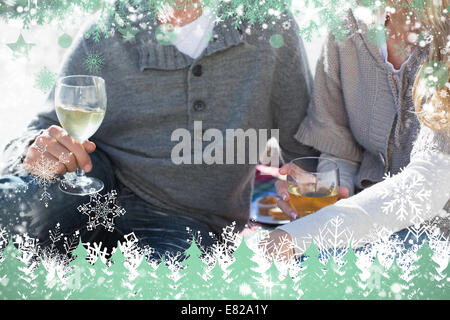 Couple enjoying white wine on picnic at the beach Stock Photo
