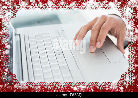 Hand using laptop at office desk Stock Photo