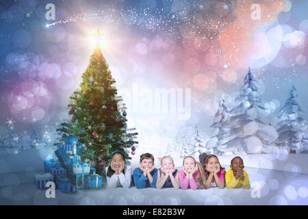Composite image of cute children smiling at camera Stock Photo