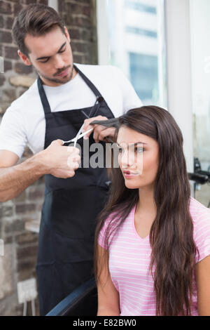 Pretty brunette getting her hair cut Stock Photo