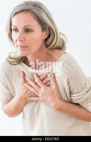 Woman suffering from a mild heart attack. Stock Photo