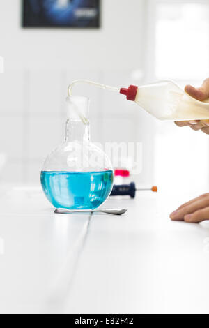 Scientist doing experiments, mixing chemicals and test samples Stock Photo