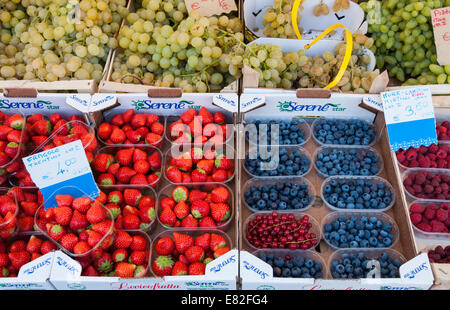 Strawberries, blueberries, raspberries and white grapes for sale in a market in Rome, Italy Stock Photo
