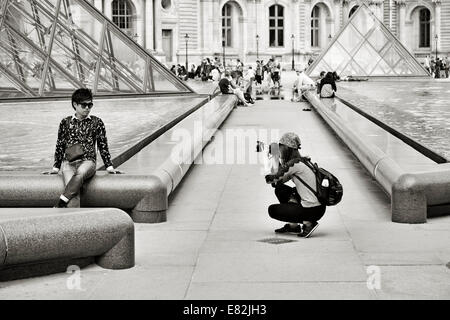 Tourists taking photos in Louvre, Paris Stock Photo