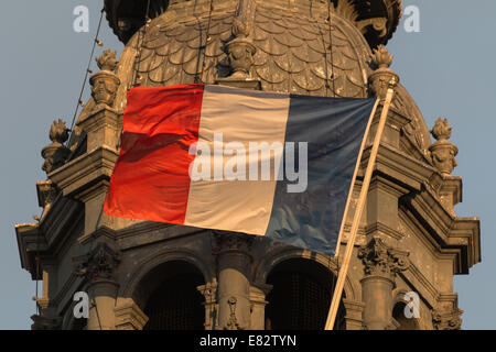 The national flag of France, a tricolour flag featuring the three colours blue, white and red, outside the Hôtel de Ville, Paris Stock Photo