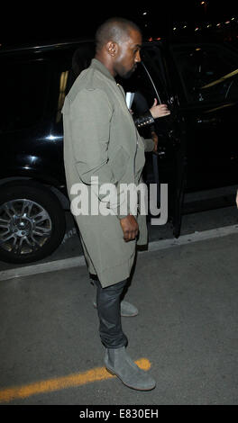 Kanye West and Kim Kardashian arrive at Los Angeles International (LAX) airport  Featuring: Kanye West Where: Los Angeles, California, United States When: 24 Mar 2014 Stock Photo