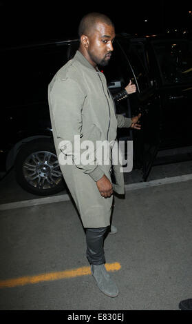 Kanye West and Kim Kardashian arrive at Los Angeles International (LAX) airport  Featuring: Kanye West Where: Los Angeles, California, United States When: 24 Mar 2014 Stock Photo