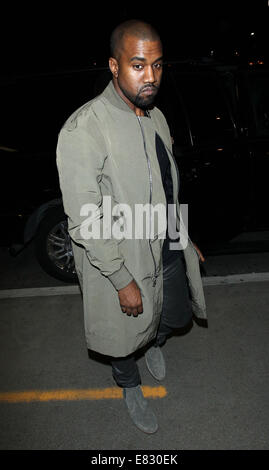 Kanye West and Kim Kardashian arrive at Los Angeles International (LAX) airport  Featuring: Kanye West Where: Los Angeles, California, United States When: 24 Mar 2014 Stock Photo