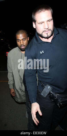 Kanye West and Kim Kardashian arrive at Los Angeles International (LAX) airport  Featuring: Kanye West Where: Los Angeles, California, United States When: 24 Mar 2014 Stock Photo