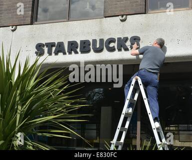 The former headquarters of Anglo Irish Bank on St Stephen’s Green has new Starbucks sign erected in place where the old infamous Anglo sign was located. For many, the Anglo Irish Bank sign was a symbol synonymous with The Celtic Tiger and the subsequent harsh economic climate & recession in Ireland in recent years - its removal made both national and international news headlines  Featuring: Starbucks Where: Dublin, Ireland When: 25 Mar 2014 Stock Photo