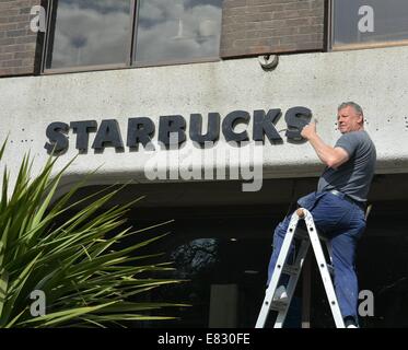 The former headquarters of Anglo Irish Bank on St Stephen’s Green has new Starbucks sign erected in place where the old infamous Anglo sign was located. For many, the Anglo Irish Bank sign was a symbol synonymous with The Celtic Tiger and the subsequent harsh economic climate & recession in Ireland in recent years - its removal made both national and international news headlines  Featuring: Starbucks Where: Dublin, Ireland When: 25 Mar 2014 Stock Photo