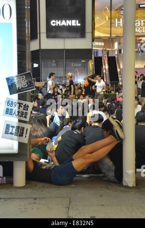 Hong Kong. 29th Sep, 2014. Hong Kong Protests: Some protestors rest as thousands of young people wearing black T-shirts take part in the second night of a pro-democracy sit-in known as 'Occupy Central', blocking traffic on Hennessy Road, an otherwise busy multi-lane thoroughfare in Causeway Bay, Hong Kong. The mood was calm and celebratory, whereas the night before, in the Admiralty district, protestors faced tear gas, pepper spray and batons from police in full riot gear. Credit:  Stefan Irvine/Alamy Live News Stock Photo