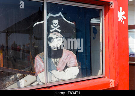 A pirate figure stares out at an amusement arcade, Devon, UK Stock Photo