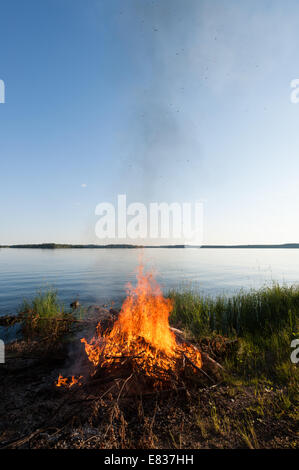 Midsummer night's bonfire by lake Päijänne, Finland Stock Photo