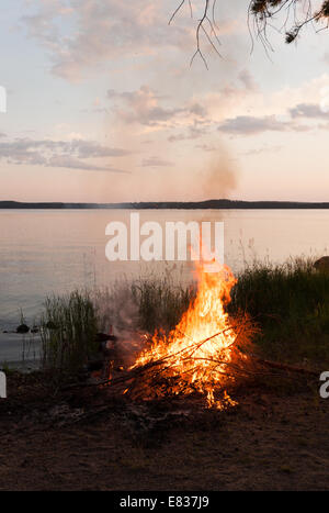 Midsummer night's bonfire by lake Päijänne, Finland Stock Photo