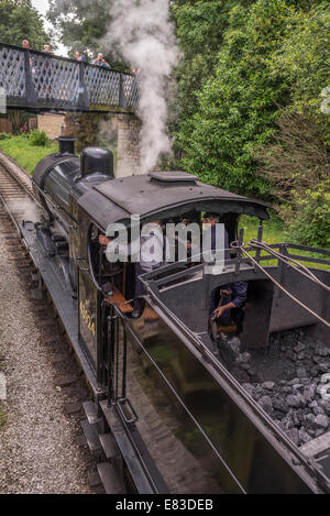 LMS Class 4F 0-6-0 'Big Goods' engine hauling a passenger train at Haworth station on the Keighley and Worth Valley Railway. KWR Stock Photo