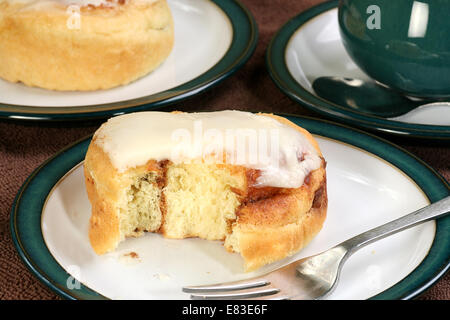 iced cinnamon bun on a plate Stock Photo