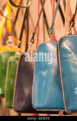 Handbags hanging in a shop. Stock Photo