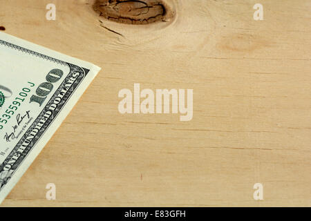 One hundred dollars on wood background Stock Photo