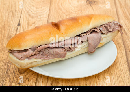 A sliced roast beef sandwich served on a white plate Stock Photo