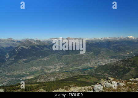 A landscape photograph looking down into a valley in the distance in the Canton of Valais in Switzerland. Stock Photo