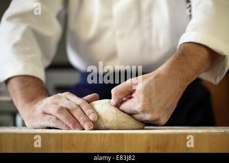 Chef kneading yeast dough Stock Photo
