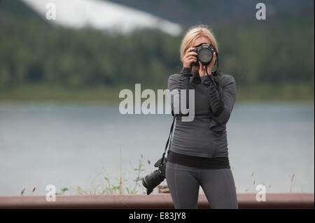 Female photographer at work in  Alaska Stock Photo