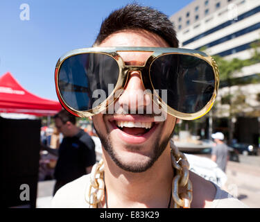 Young man wearing funny oversize novelty sunglasses - USA Stock Photo